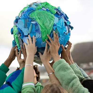 Children holding a handmade globe